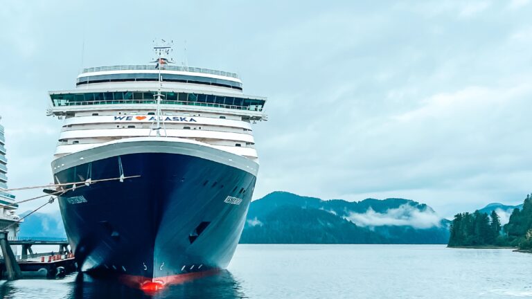 A Holland America Line cruise ship docked at an Alaskan cruise port